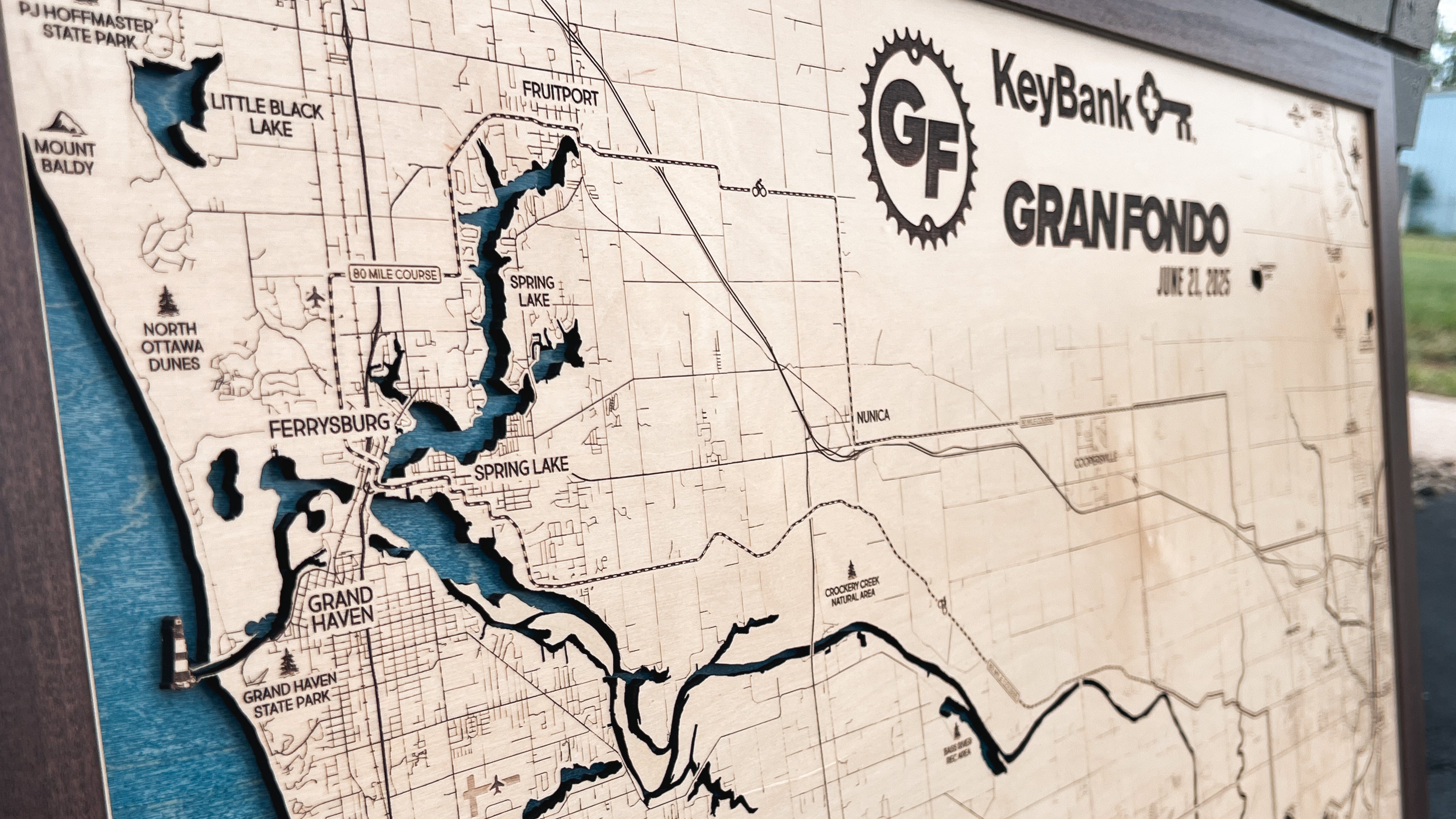 Wooden map with KeyBank Gran Fondo logo and route details